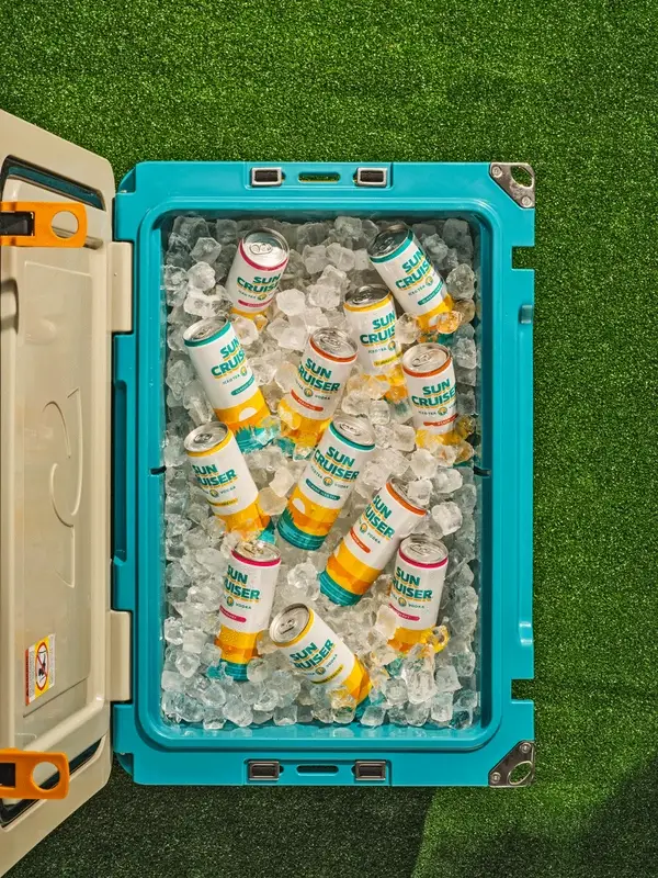 Cooler full of Sun Cruiser vodka iced tea cans on ice